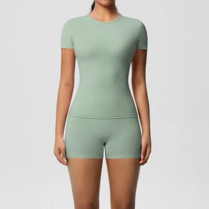 Detail of high-elasticity sage green yoga set with slim-fit top and high-waist shorts