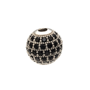 Macro shot of silver metal spherical bead pavé-set with sparkling black zircon stones