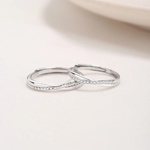 Elegant S925 sterling silver Mobius couple rings set with diamond accents and twisted texture
