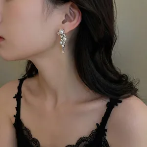 Silver fringe earrings with pearls and rhinestones on model for a trendy look