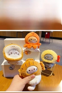 Close-up of cute plush cat keychains in octopus and toast costumes with embroidery