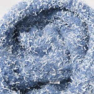 Sky blue and white knit beanie featuring thick plush wool and inner care label detail