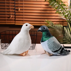Realistic white and gray pigeon plush toys with soft textures on a clean background