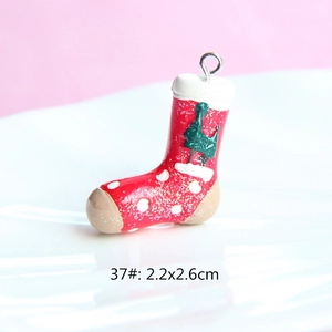 Detail of red resin Christmas stocking pendant with silver loop and sizing 2.2x2.6cm