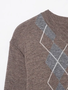 Close-up of the ribbed neckline and grey argyle pattern on brown wool blend sweater