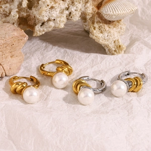 Detail of French vintage 18K gold and silver knot hoop earrings with white pearls