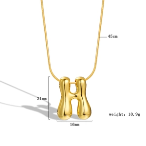 Macro view of golden puff initial H pendant with measurements and snake chain details