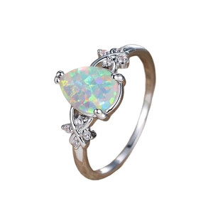 Elegant white opal teardrop ring with side diamonds in polished silver setting