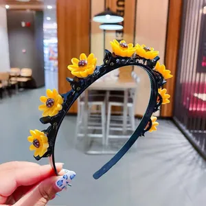 Detail of yellow sunflower clips on black plastic headband with 11.3cm diameter scale