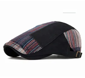 Detail view of retro patchwork beret featuring black fabric and striped pattern with side buckle