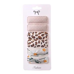 Detail of 6-piece square hair clips featuring floral embroidery and leopard patterns