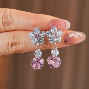 Detail of silver flower earrings with pink and white cubic zirconia crystals