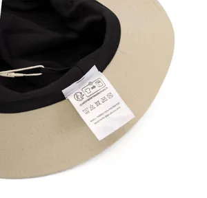 Detail shot of the care label showing 100% polyester fabric on the brim of the sun hat