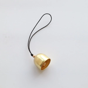Detail of 2cm golden brass bell with black cord and gold bead for DIY craft hanging