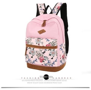 Detail view of pink floral backpack showing premium brown faux leather trim and accents
