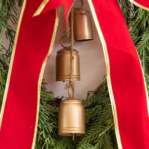 Bohemian Christmas wreath with three vintage brass bells and a large red bow decoration