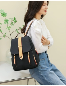 Detail of waterproof nylon backpack showing heart buckle and contrast straps on front