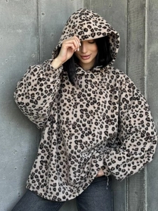Detailed close-up of oversized leopard print fleece hoodie texture and plush fabric finish