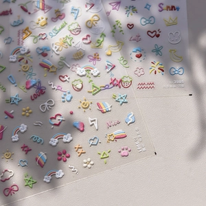 Detail of 3D embossed nail stickers featuring rainbow, heart, and star patterns