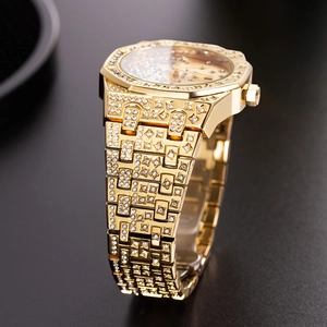 Detail of luxury gold-tone watch fully iced out with sparkling crystals on dark surface