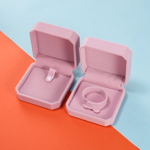 Detail of pink velvet jewelry box with internal slots for necklaces and bracelets