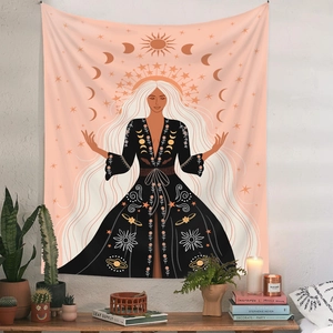 Detail of Bohemian tapestry with moon phase woman and sun elements on a white wall