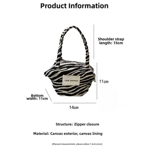 Detailed canvas zebra print handbag with dimensions 14x11cm and secure zipper closure