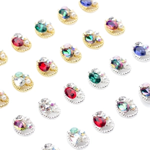 Oval rhinestone nail charms with twisted alloy borders and pearls in various colors