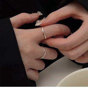 Close-up of minimalist S925 sterling silver wavy ring worn on model's finger