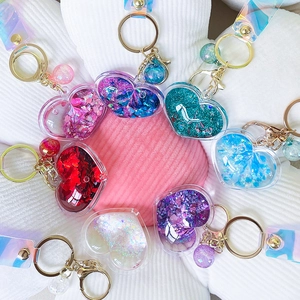 Creative heart-shaped quicksand keychains with colorful sequins and liquid filling