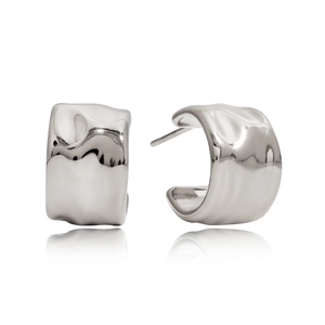 Macro detail of silver-toned irregular C-shaped earrings with wave texture finish