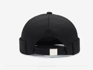 Rear view of black docker cap featuring adjustable fabric strap and metal buckle closure