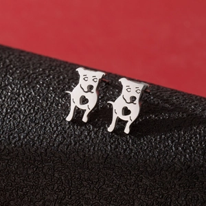 Polished silver stainless steel pug dog stud earrings with heart cutout on red background