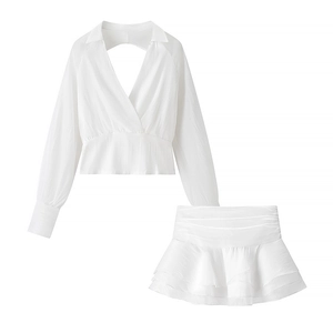 Fashionable white two-piece set featuring long sleeve V-neck top and layered ruffle mini skirt