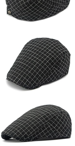 Detailed close-up of a black and white checkered flat cap with side metal buckle accents