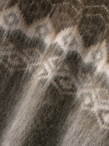 Macro shot of fluffy jacquard knit fabric with vintage brown geometric diamond patterns