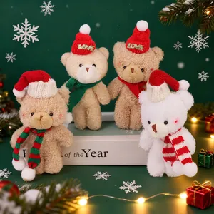 Christmas plush bear keychain set with red hats and scarves on festive pine background