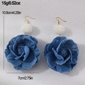 Detail view of denim rose earrings with pearl studs and size measurements in inches