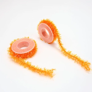 Detail of two rolls of orange tinsel garland for DIY Halloween decorations with wire core
