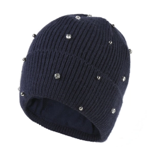 Detailed view of navy blue ribbed knit beanie featuring sparkling rhinestones and silver beads
