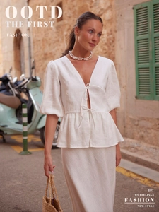 Detail of white cotton v-neck tie-front top with puff sleeves and long skirt summer set