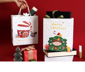 Close-up of Christmas gift bags featuring cartoon house and tree illustrations in festive red