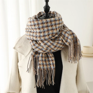 Detail of classic blue and beige plaid scarf showing soft fringe and thick cashmere texture