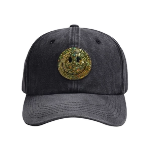 Washed denim baseball cap in dark grey featuring a golden sequin smiley face patch