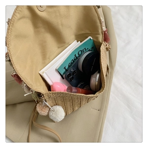 Top-down view of woven straw bag interior showing large capacity for phone and cosmetics