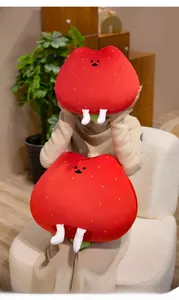 Detail view of plush strawberry pillows with cute white legs in a cozy home setting