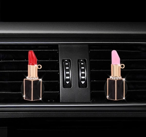 Detailed view of lipstick-shaped car air vent aromatherapy clips with rhinestones