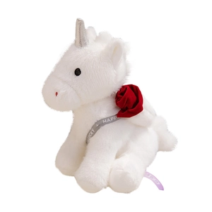 White unicorn plush toy with silver horn and red rose flower on a clean white background
