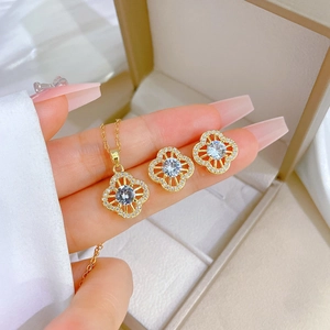 Luxe gold titanium four-leaf clover jewelry set with sparkling pavé crystals