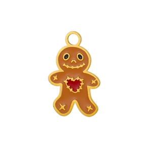 Detailed view of gingerbread man charm with brown enamel and red heart pattern